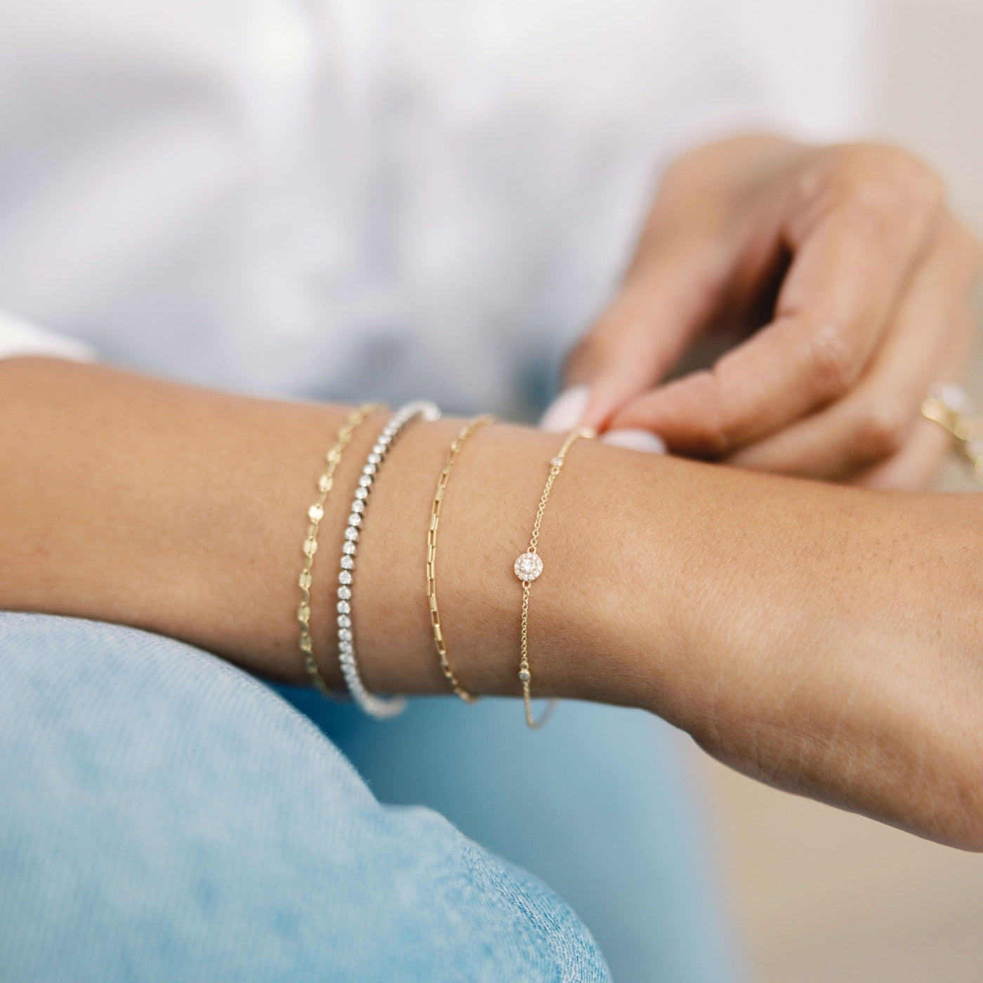 All the Sparkles Diamond Bracelet and other gold and diamond bracelets on Nasreen Shahi's wrist, showcasing a chic and layered jewelry look