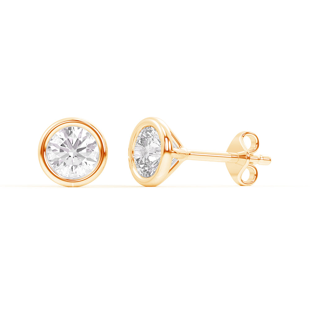 Lab-grown diamond bezel stud earrings in 14K yellow gold, featuring a sleek bezel setting for a contemporary and minimalist design