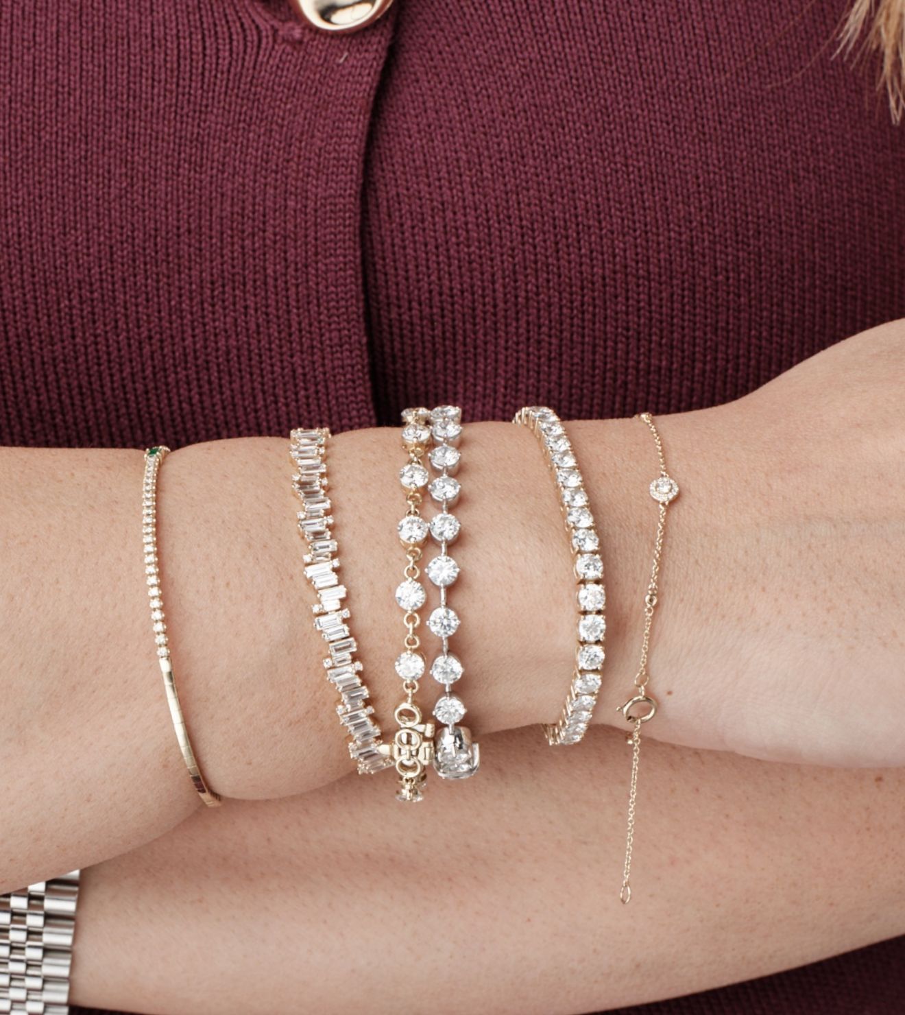 Close-up of a wrist adorned with diamond and gold bracelets from Seema Jewelry and Co.