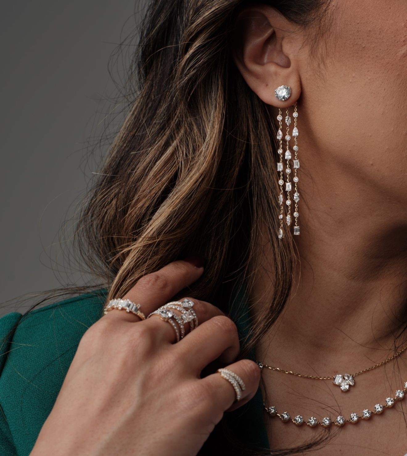 Side profile showcasing statement diamond earrings and rings by Seema Jewelry and Co.