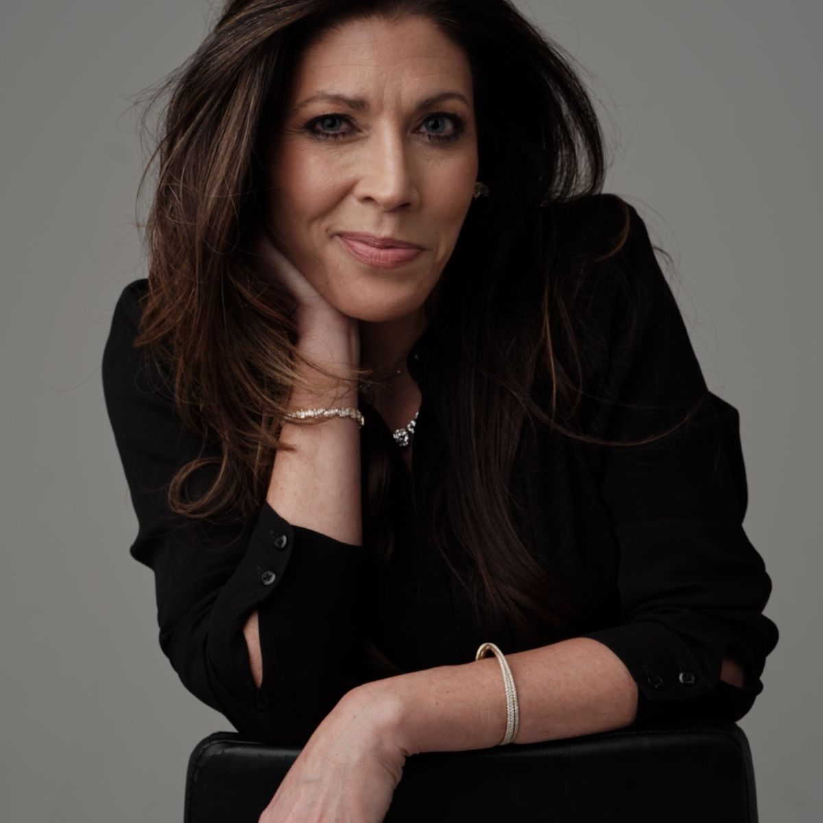 Portrait of a woman wearing bracelets and a necklace from Seema Jewelry and Co.